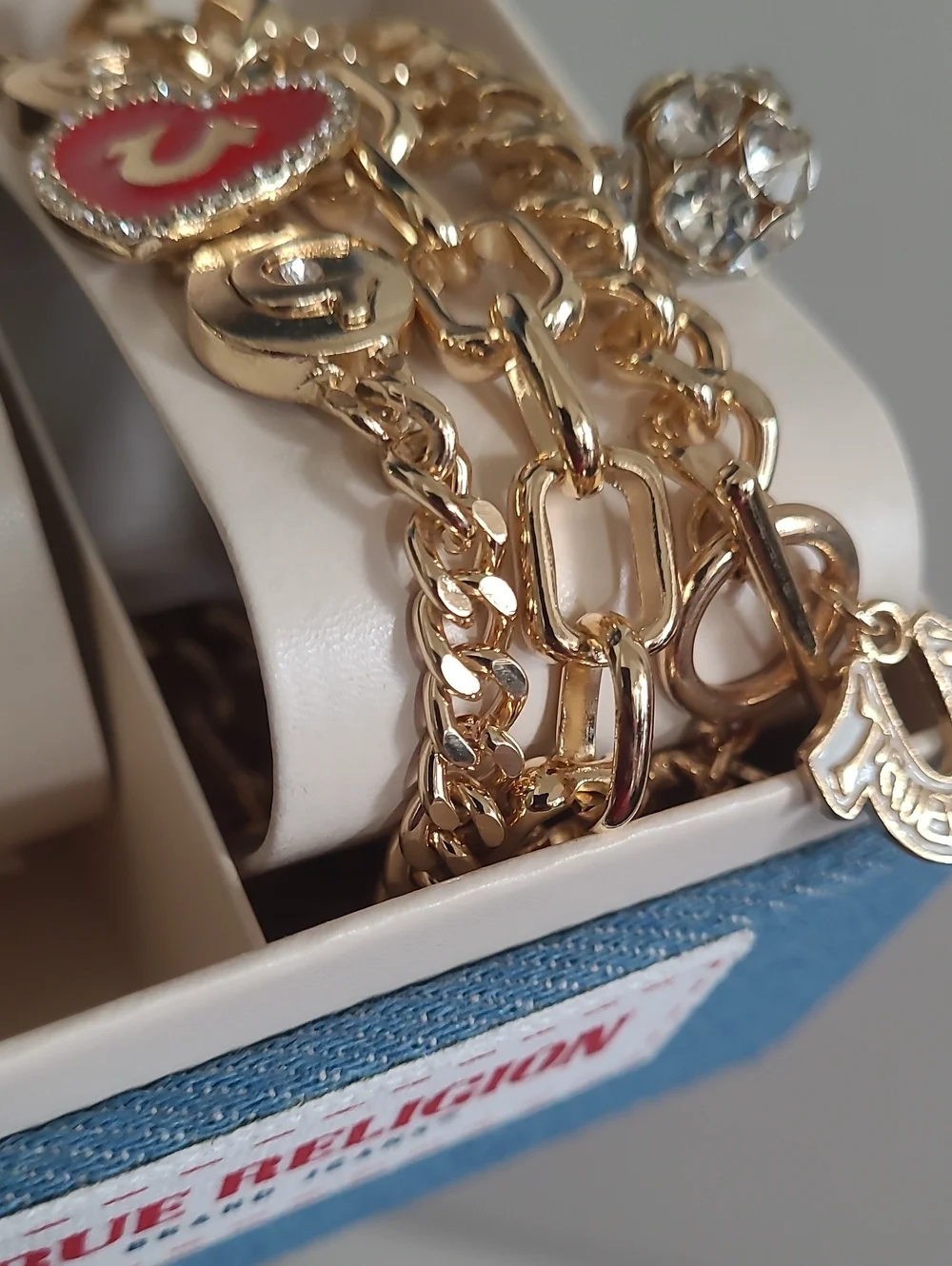 True Religion Gold-Tone Watch with Black Dial and Charm Bracelet
